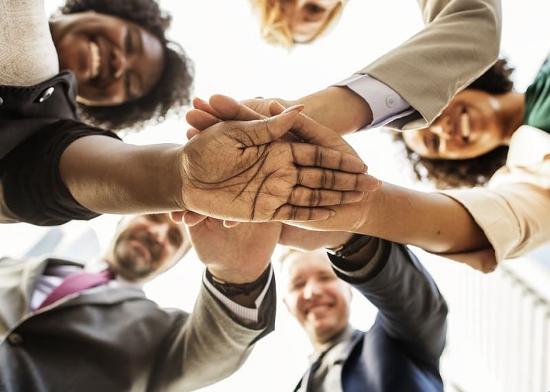 group of people hands stack support together