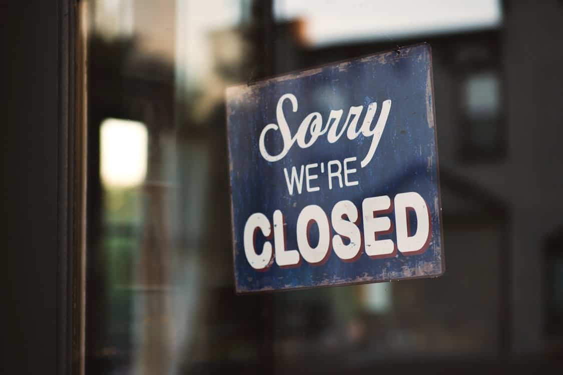 sorry we are closed sign hanging outside a restaurant