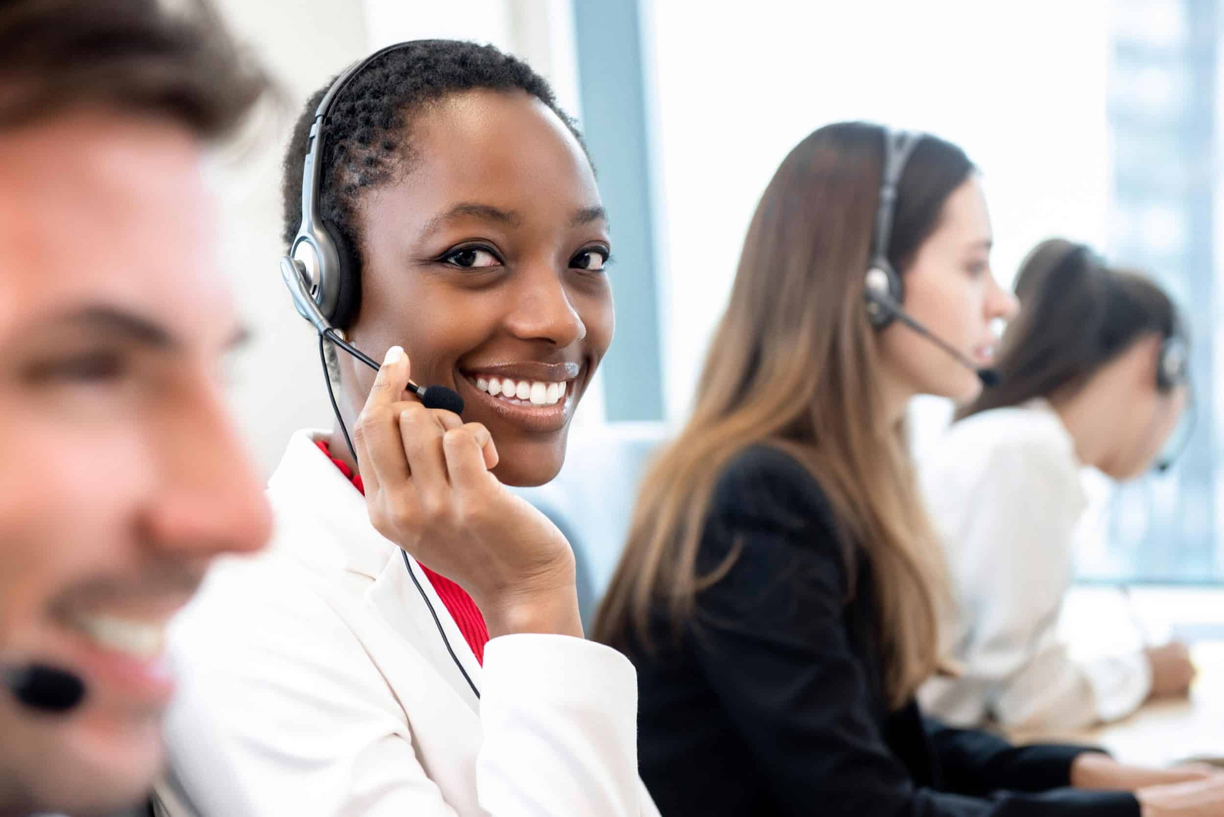 Smiling beautiful African American woman working in call center office