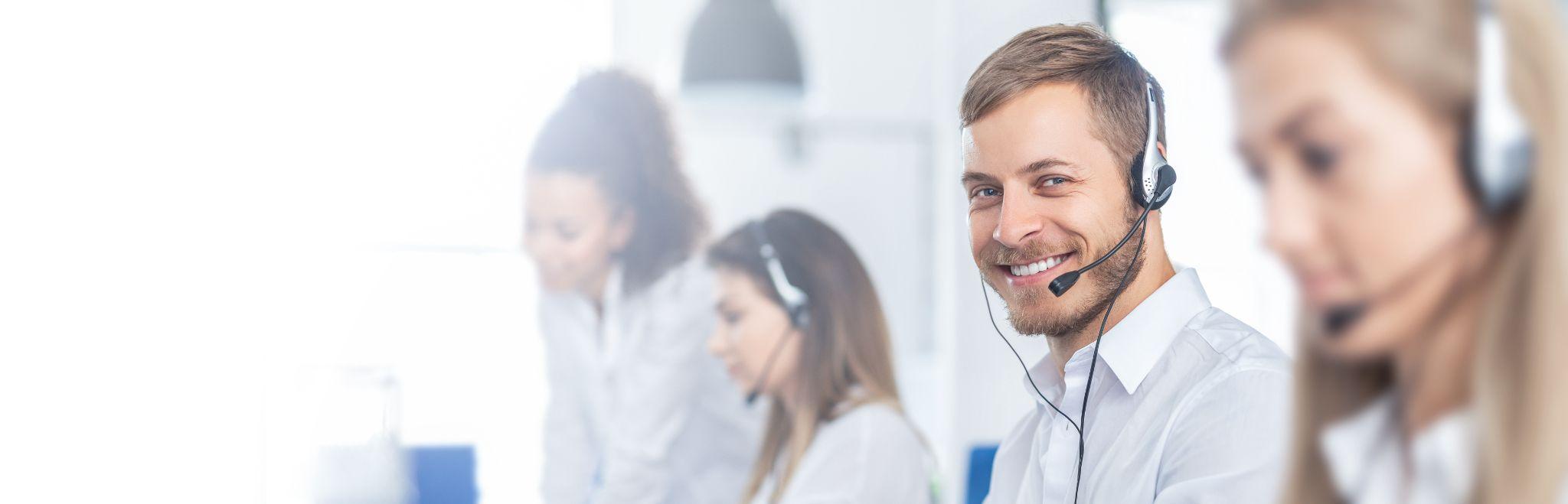 Focus at businessman in headset while consulting customers