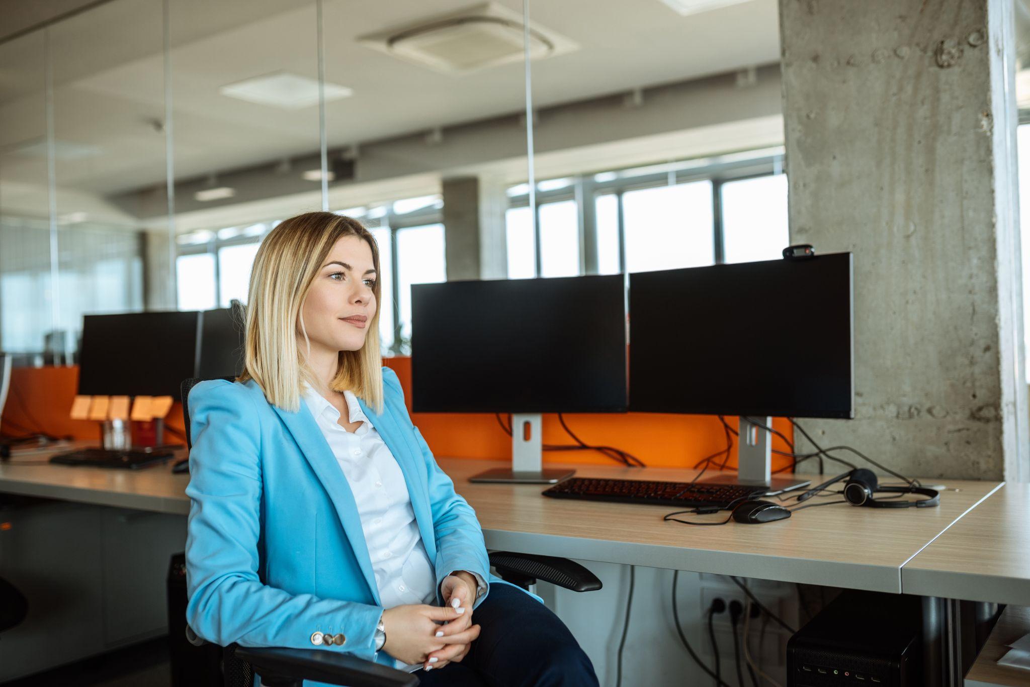 Confident and successful business woman sitting in office