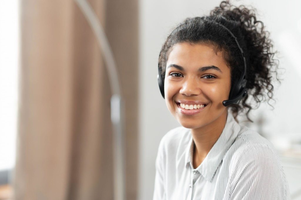 Friendly charming African American mixed-race woman in headset