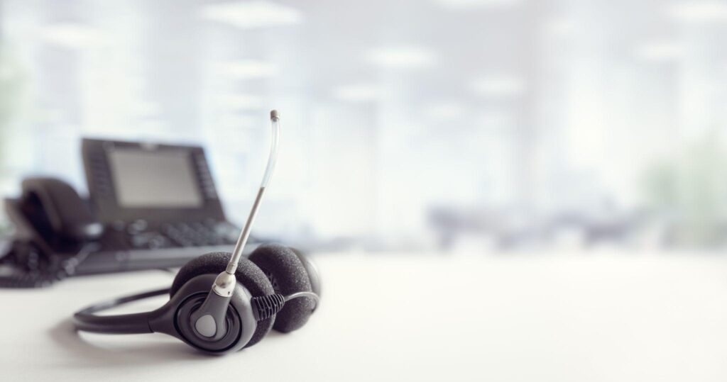 Headset headphones telephone on desk in call center